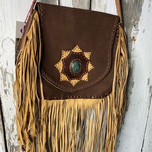 Guatemalan artisan fringe bag with jade medallion